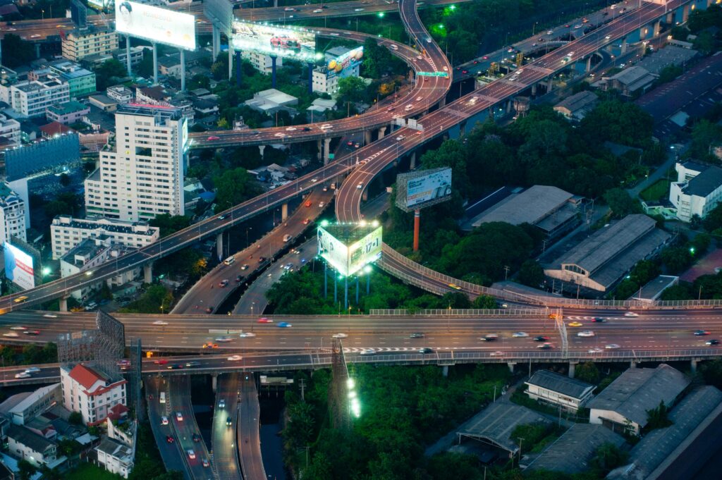pexels-photo-1031669-1031669 Dynamic aerial view of a bustling Bangkok expressway intersection with city lights.
